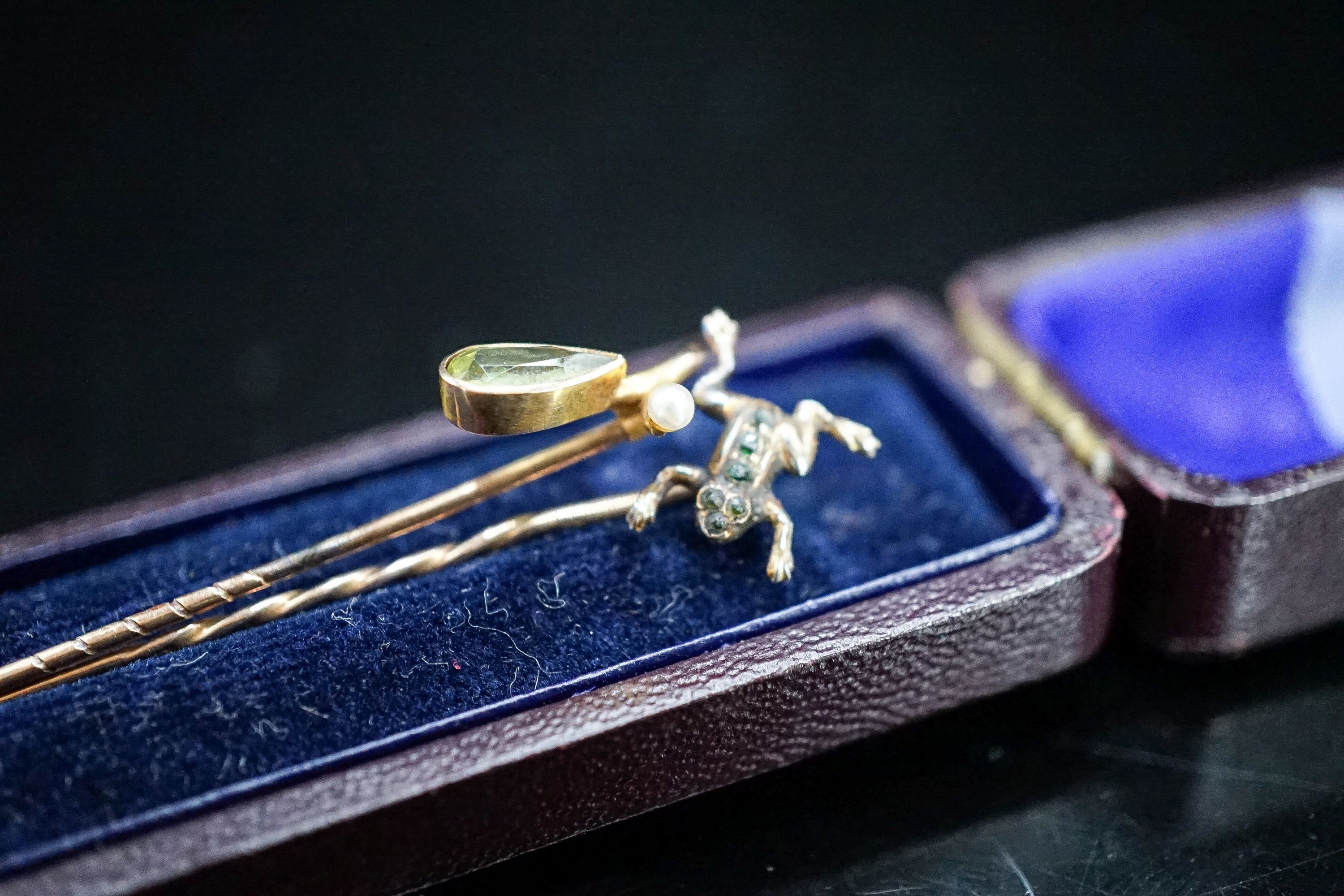 An early 20th century 9ct and gem set frog stick pin, stamped MB & Cie, 57mm and one other 9c and gem set stick pin, gross weight 2.2 grams.